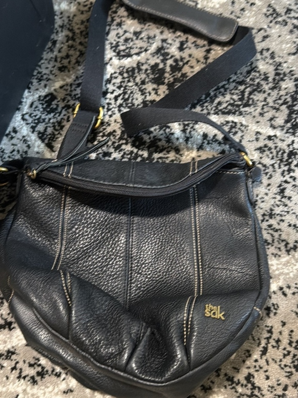 The Sak Black Pebbled Leather Crossbody with Gold Logo